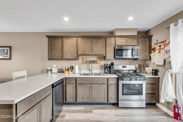 a kitchen with a sink stove and microwave