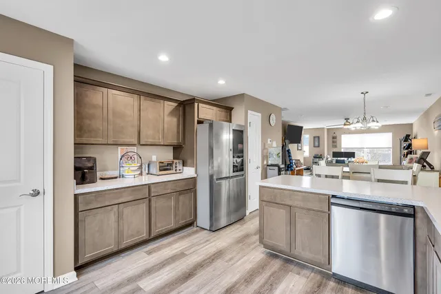 a kitchen with refrigerator and cabinets