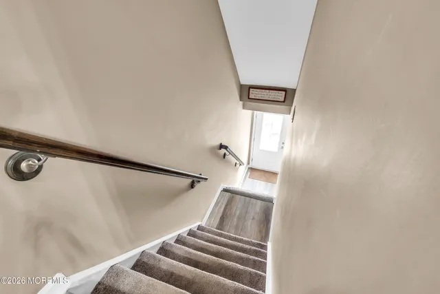 view of room with stairs and a floor to ceiling window