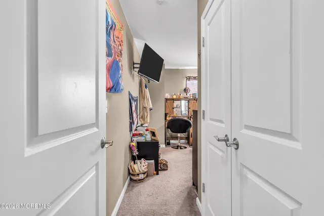 a view of walk in closet with clothes and shoes