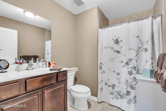 a bedroom with two beds and a large window