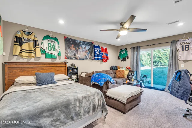 a bedroom with furniture and a flat screen tv