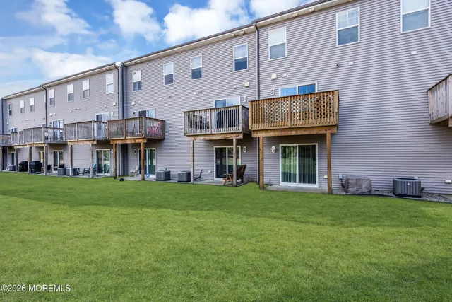 a view of a two chairs in the backyard