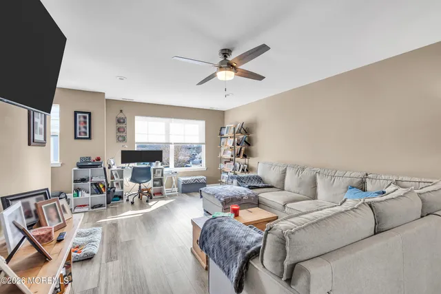 a living room with furniture and a wooden floor