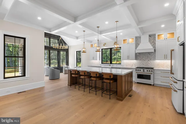 a living room with furniture and large windows