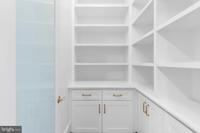 a hallway view with staircase