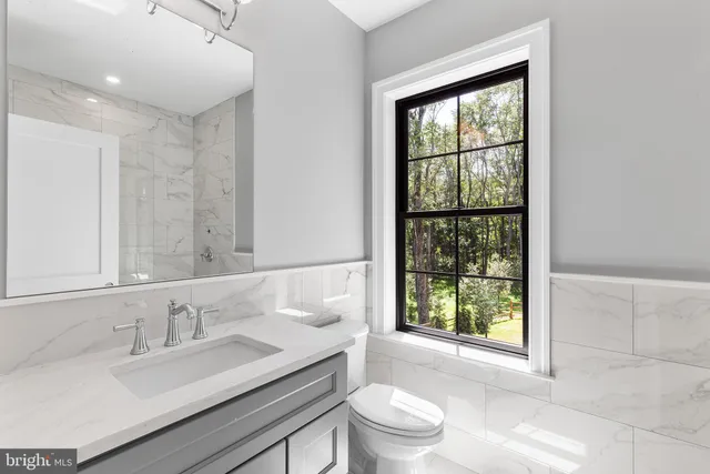 a front view of a house with swimming pool garden and patio