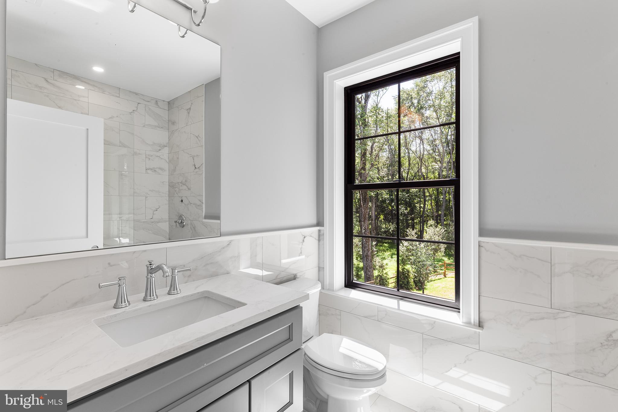 153 Kirk Road Garnet Valley, PA 19060 - Photo 37 of 66 a bathroom with a granite countertop sink a toilet a mirror and window