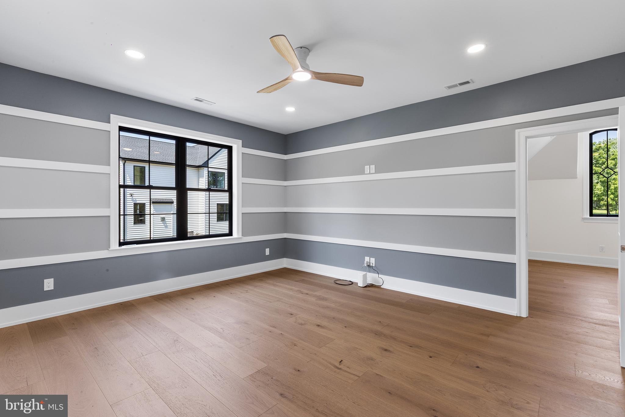 153 Kirk Road Garnet Valley, PA 19060 - Photo 39 of 66 a view of an empty room with a window and wooden floor