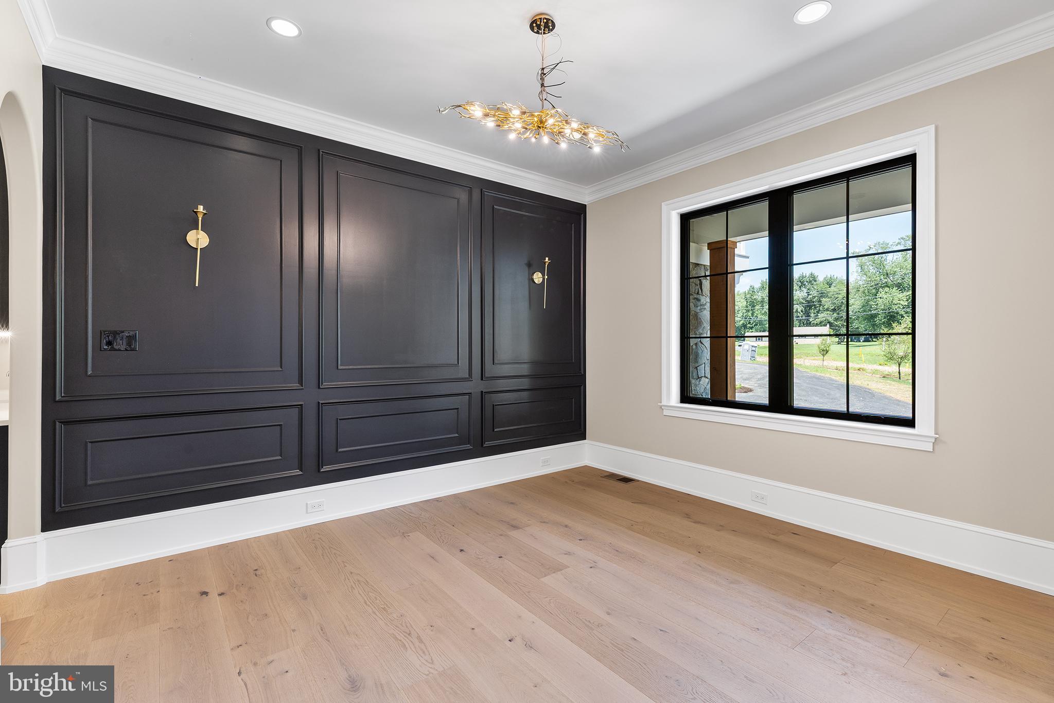 153 Kirk Road Garnet Valley, PA 19060 - Photo 4 of 66 a view of an empty room with wooden floor and a window