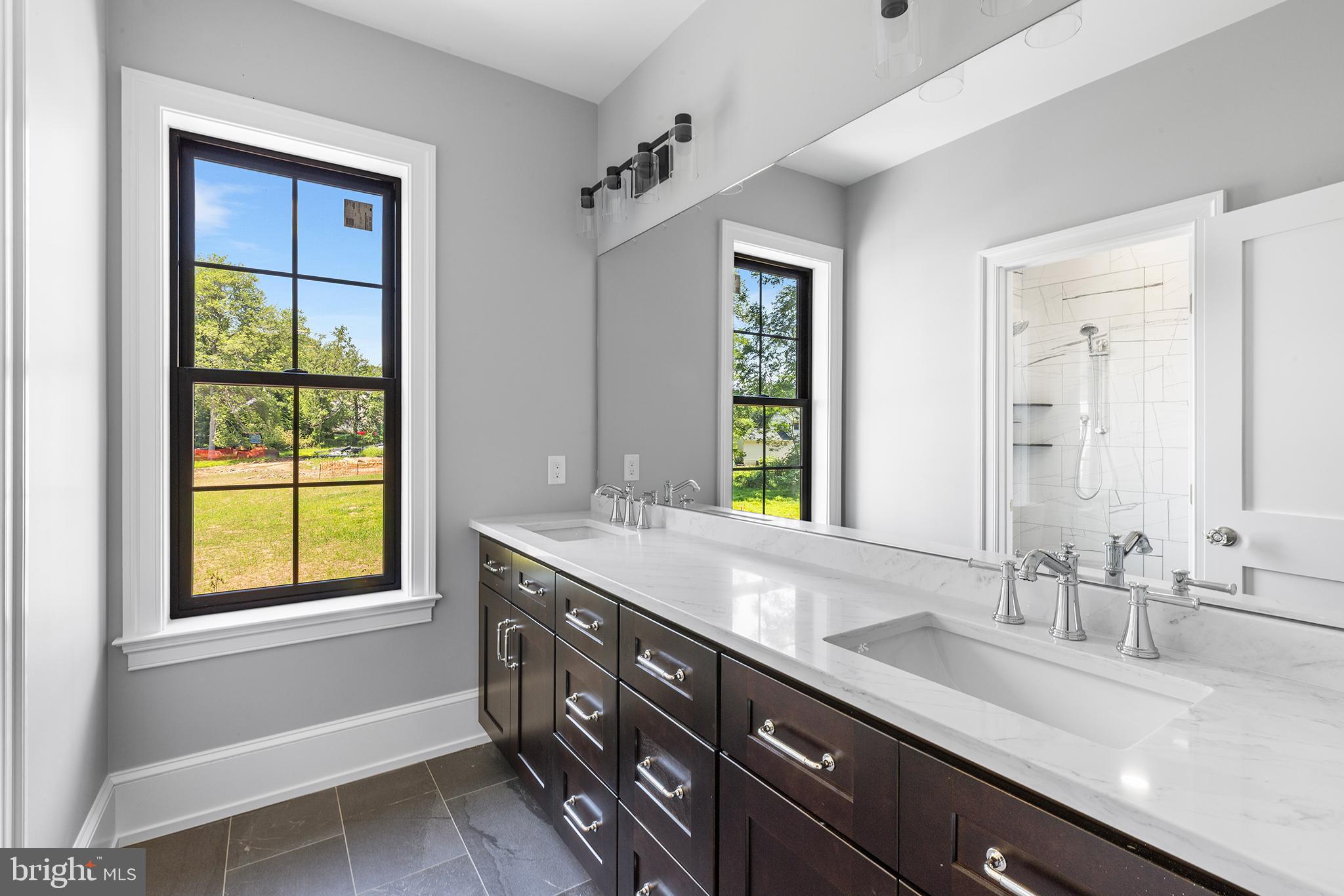 153 Kirk Road Garnet Valley, PA 19060 - Photo 41 of 66 a bathroom with a granite countertop sink mirror and a window