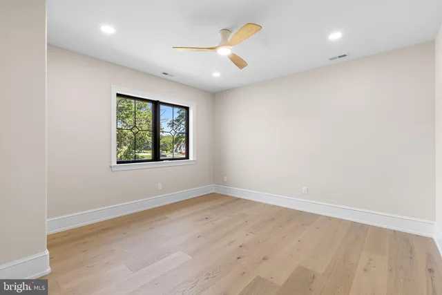 a view of a white house with a yard and outdoor seating