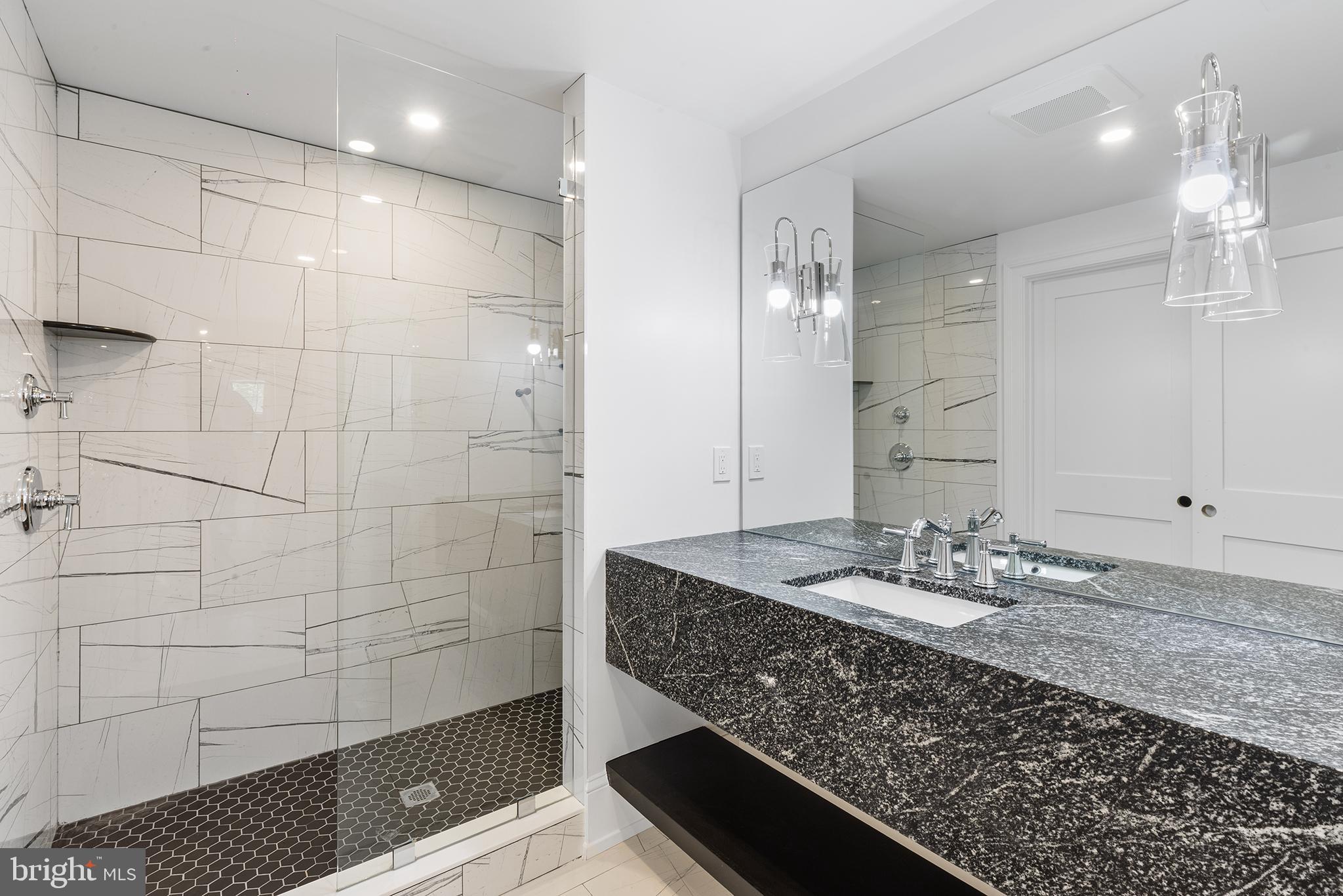 153 Kirk Road Garnet Valley, PA 19060 - Photo 51 of 66 a bathroom with a granite countertop sink a mirror and shower