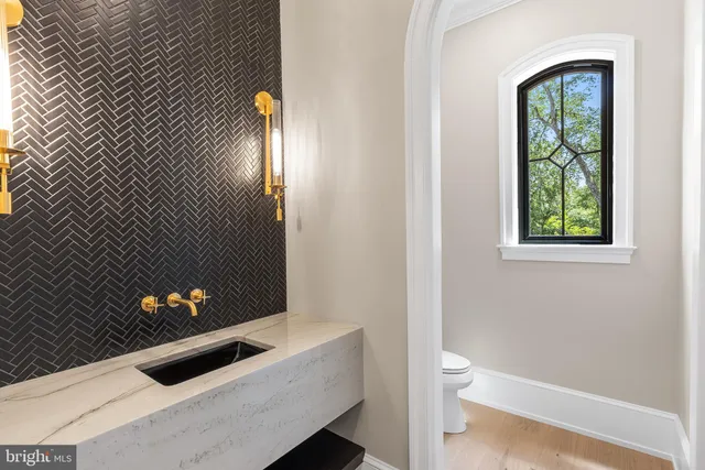 a living room with furniture ceiling fan and a large window