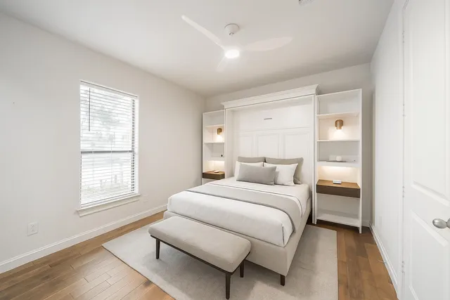 a bedroom with a bed and a window