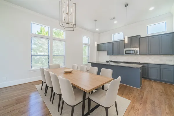 a view of kitchen with granite countertop cabinets table and chairs