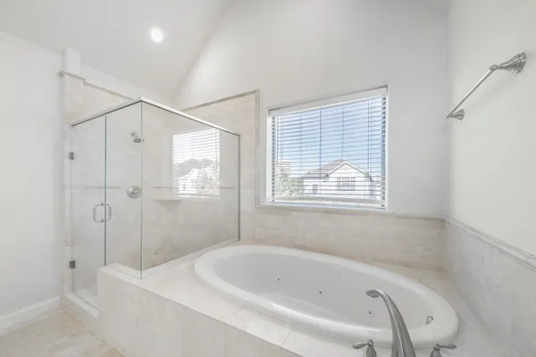 a bathroom with a bathtub and a shower