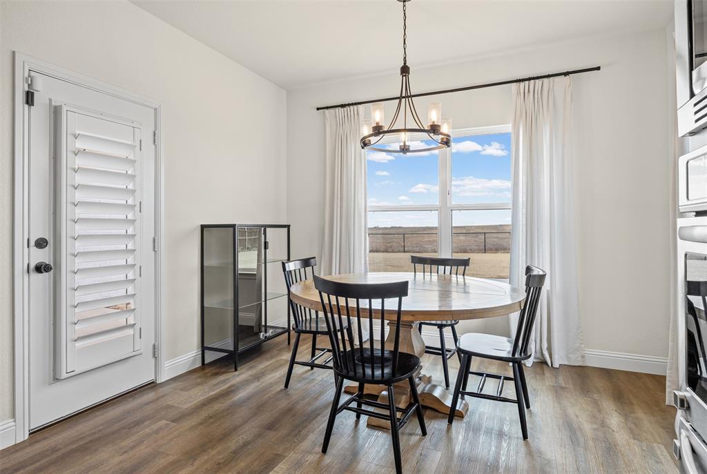 9437 Wildcat Ridge Godley, TX 76044 - Photo 12 of 37 a view of a dining room with furniture window and wooden floor