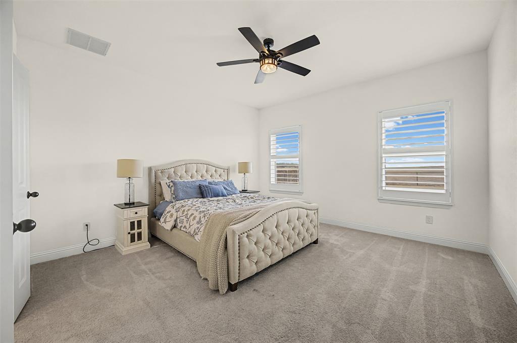 9437 Wildcat Ridge Godley, TX 76044 - Photo 13 of 37 a bedroom with a bed and window