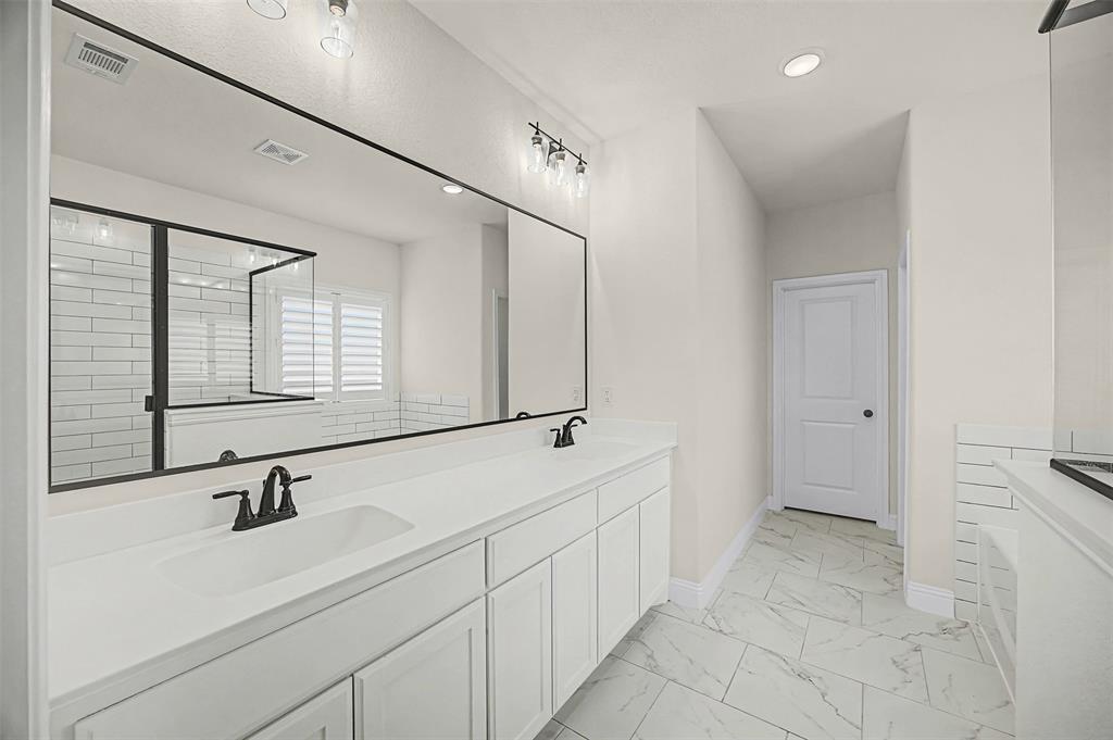 9437 Wildcat Ridge Godley, TX 76044 - Photo 14 of 37 a bathroom with a sink and a mirror