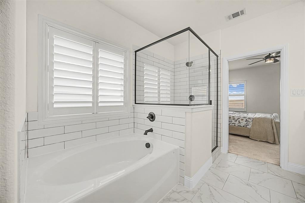 9437 Wildcat Ridge Godley, TX 76044 - Photo 15 of 37 a bathroom with a bathtub and a shower