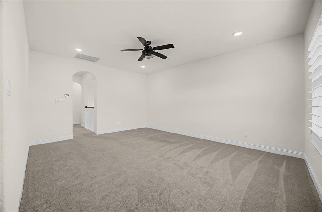 9437 Wildcat Ridge Godley, TX 76044 - Photo 19 of 37 an empty room with a ceiling fan and a window