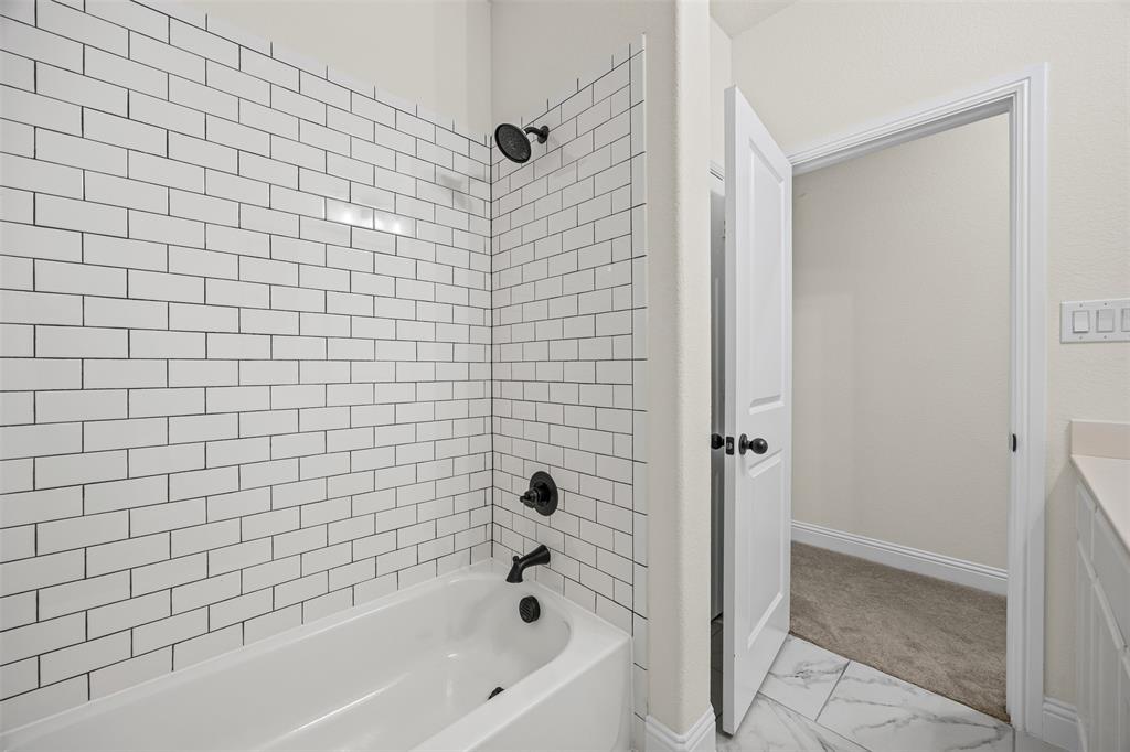 9437 Wildcat Ridge Godley, TX 76044 - Photo 21 of 37 a bathroom with a bathtub and a shower