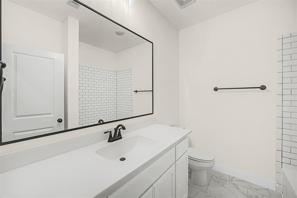 9437 Wildcat Ridge Godley, TX 76044 - Photo 22 of 37 a bathroom with a sink a toilet and shower