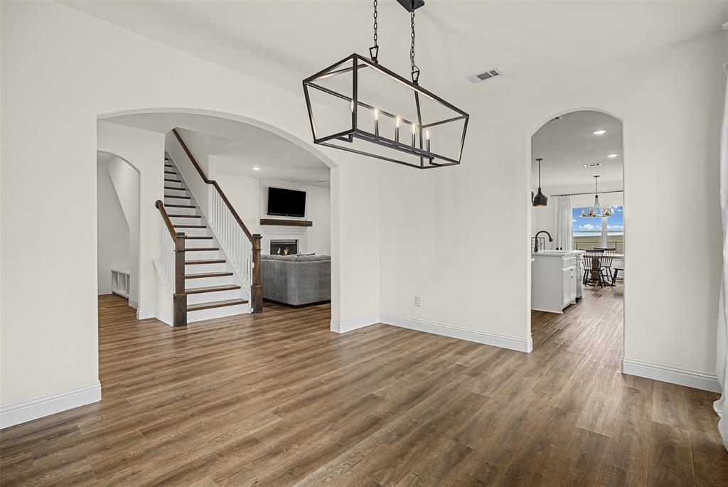 9437 Wildcat Ridge Godley, TX 76044 - Photo 6 of 37 a view of a livingroom with wooden floor and a ceiling fan