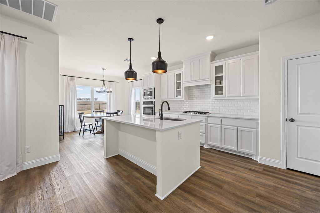 9437 Wildcat Ridge Godley, TX 76044 - Photo 9 of 37 a kitchen with white cabinets and sink