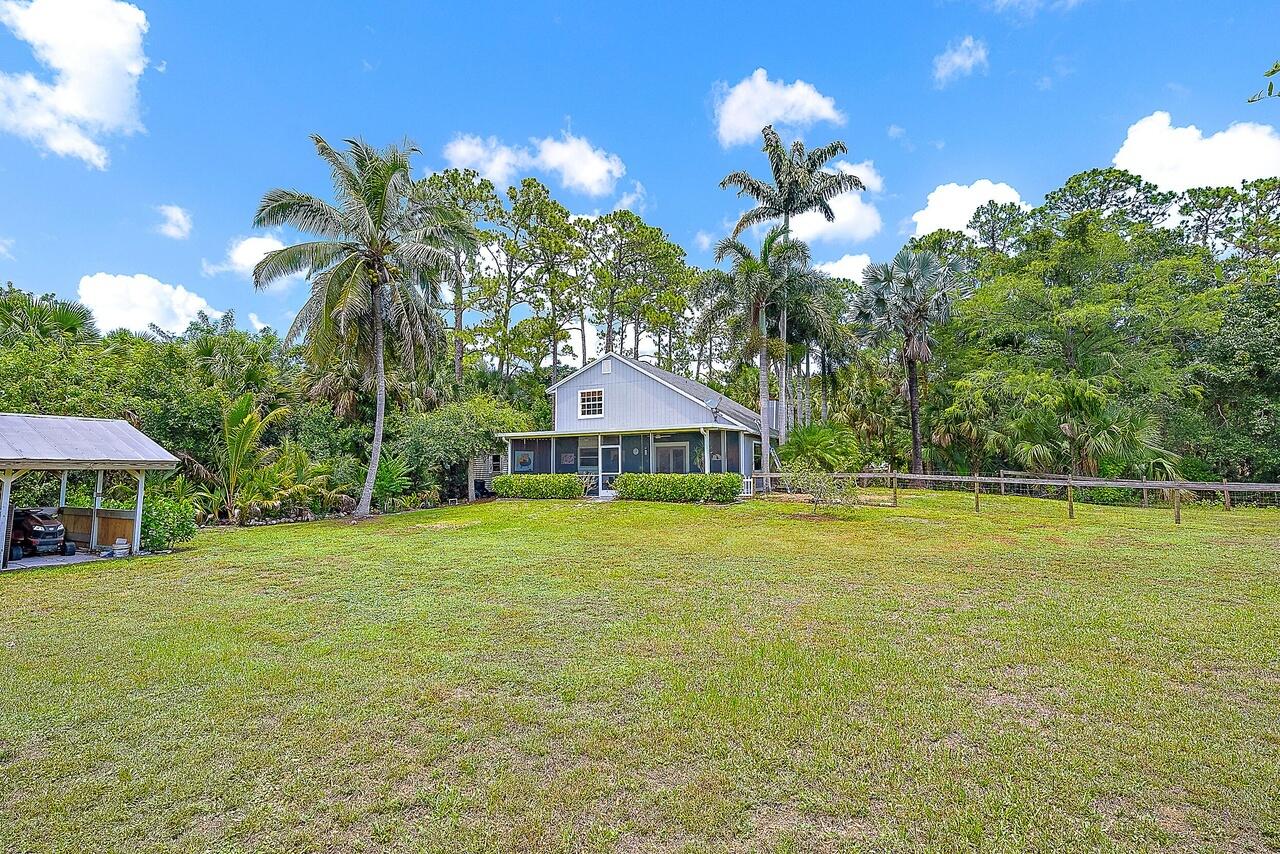 15629 95th Avenue North Jupiter, FL 33478 - Photo 20 of 22 a house view with a swimming pool