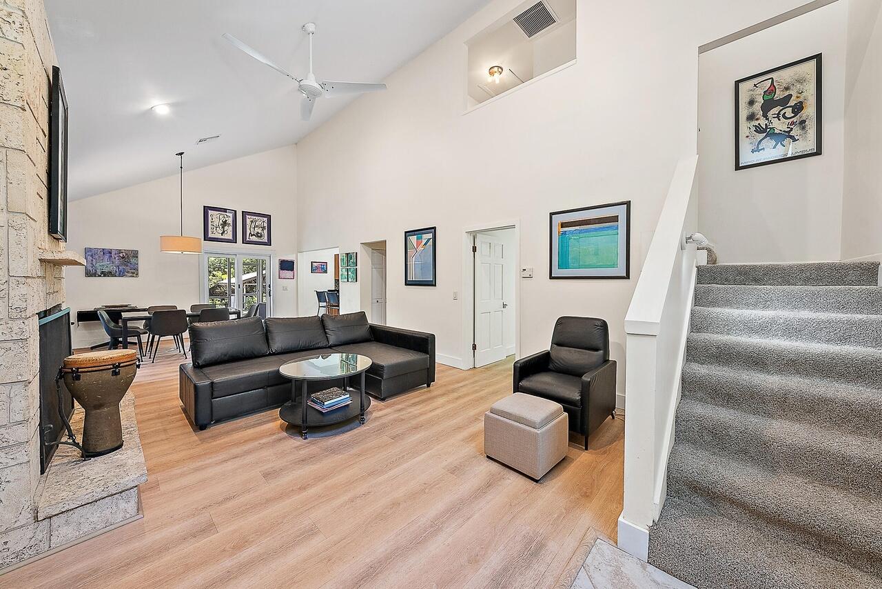15629 95th Avenue North Jupiter, FL 33478 - Photo 3 of 22 a living room with furniture and a fireplace