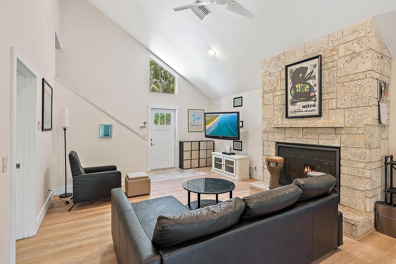 15629 95th Avenue North Jupiter, FL 33478 - Photo 4 of 22 a living room with furniture and a fireplace