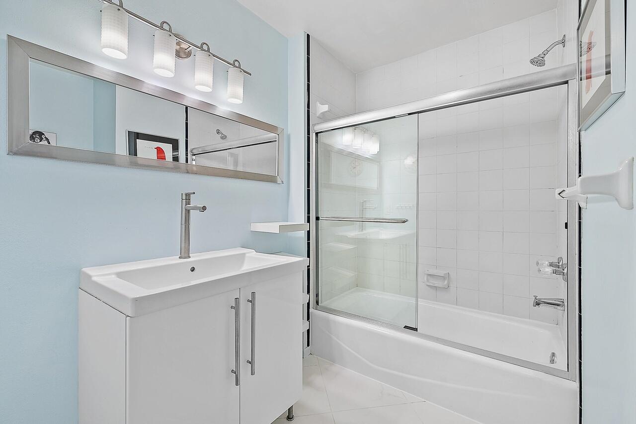 15629 95th Avenue North Jupiter, FL 33478 - Photo 10 of 22 a bathroom with a shower and a sink