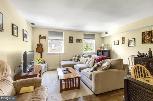 a living room with furniture fireplace and a window