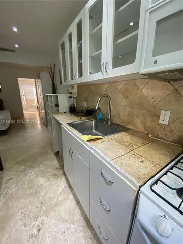 a kitchen with a sink stove and refrigerator