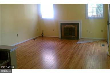 9104 Piper Ridge Court Lanham, MD 20706 - Photo 3 of 4 a view of empty room with wooden floor and fireplace