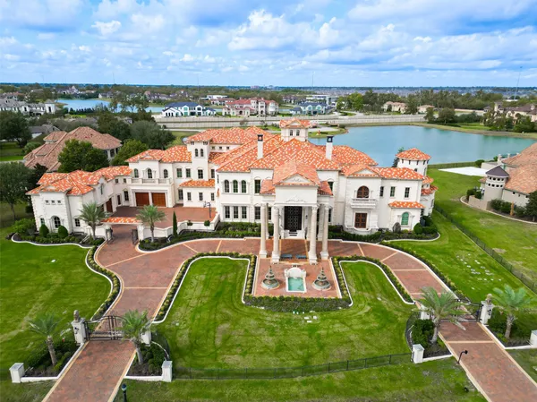an aerial view of a house with a big yard
