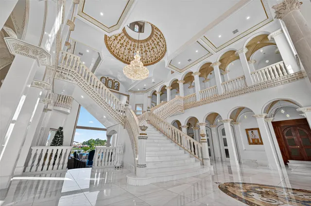 a room with pool table and windows