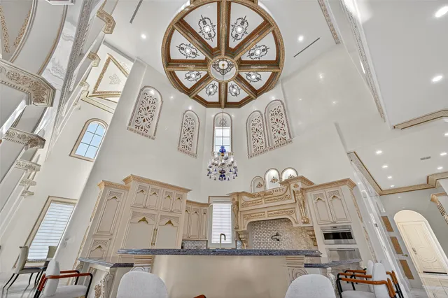 a spacious bedroom with a bed and a chandelier