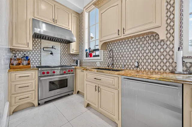 a kitchen with stainless steel appliances granite countertop white cabinets and white appliances