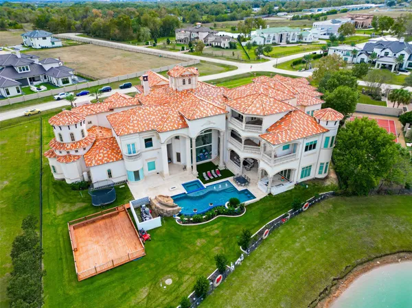 an aerial view of house with yard swimming pool and outdoor seating