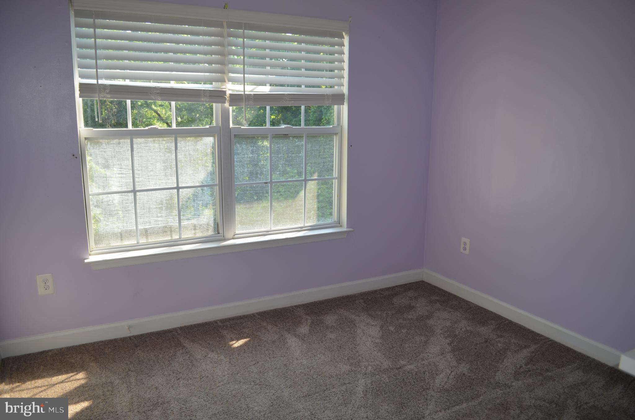 6505 Springwater Court, Unit 7403 Frederick, MD 21701 - Photo 12 of 39 1st bedroom - large window looking at woods