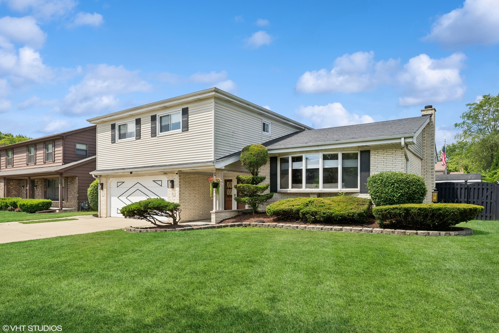 a front view of a house with a yard and outdoor seating