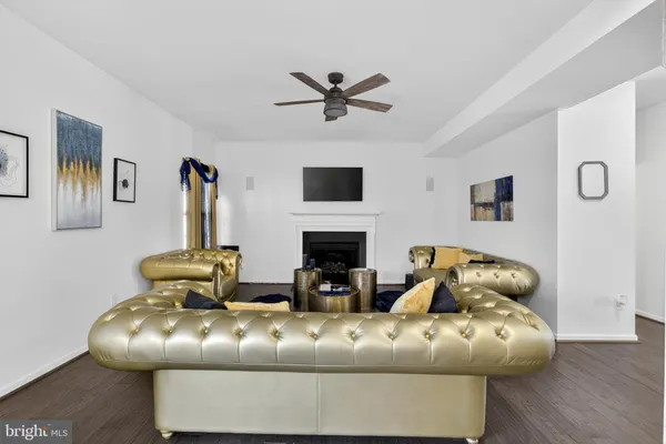 a living room with furniture kitchen view and a chandelier