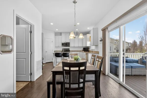 a kitchen with a refrigerator a sink a stove a microwave and cabinets