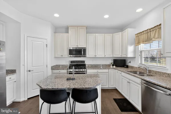 a kitchen with a stove a sink and a microwave