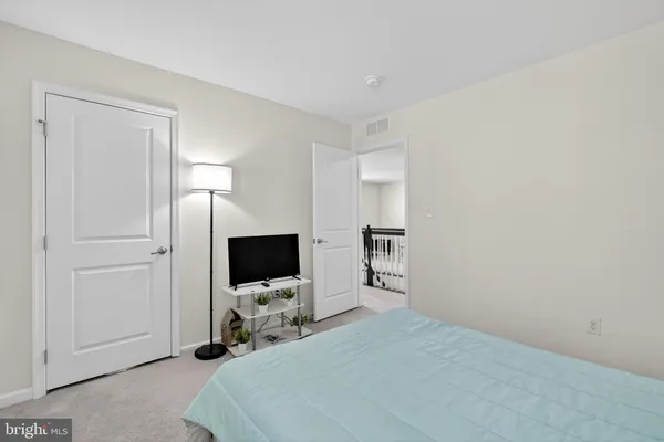 a bedroom with a large bed and a window