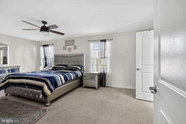 a spacious bedroom with a bed and a flat screen tv
