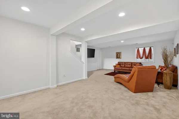 a living room with furniture and a book shelf